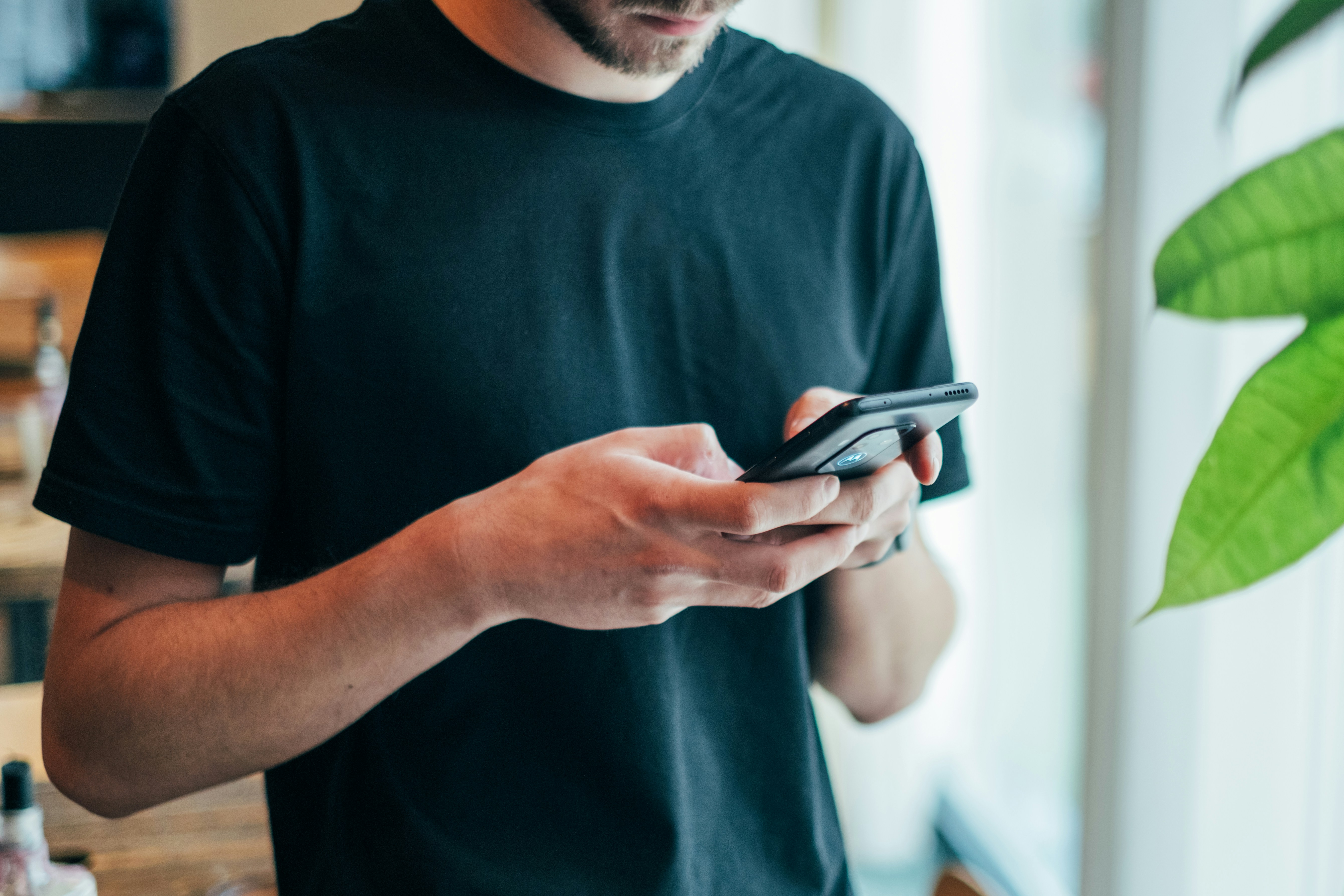 Man using smartphone in an urban setting